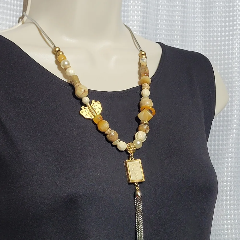 Silver and Gold Tone Necklace with a Bird, Butterfly and Beads.